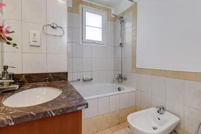 a bathroom with a sink and a tub and a toilet at The Springs 8 - 2 Bedroom with Maids Room Villa - Allsopp & Allsopp in Dubai