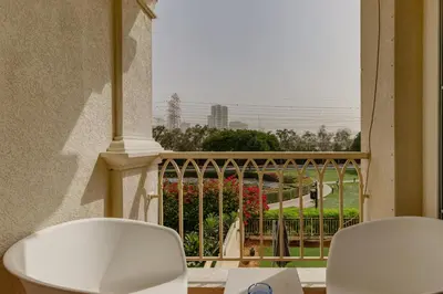 two white chairs on a balcony with a view of the ocean at The Springs 8 - 2 Bedroom with Maids Room Villa - Allsopp & Allsopp in Dubai