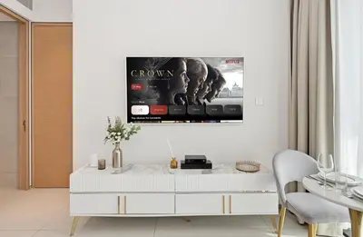 a white living room with a tv on the wall at Stylish Urban Stay in Address JBR with Canal View in Dubai
