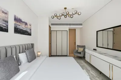 a bedroom with a large white bed and a tv at Stylish Urban Stay in Address JBR with Canal View in Dubai