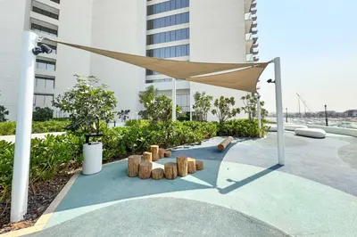 a canopy in front of a building with a building at PVH - Modern 1BR with Golf Course View - Golf Gate in Dubai