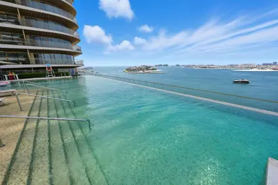 a swimming pool with a view of the water at Cozy 1BD Apartment in Grand Bleu, Emaar Beachfront in Dubai