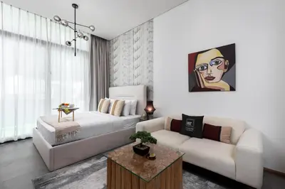 a living room with a bed and a couch at Maison Privee - Serene Studio Escape with Balcony in JVC in Dubai