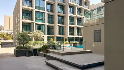 a large building with a courtyard in front of it at Maison Privee - Serene Studio Escape with Balcony in JVC in Dubai