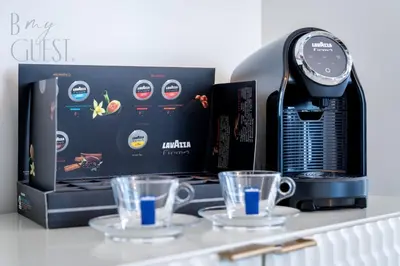 a coffee machine with two cups on a counter at Stunning 2BR Holiday Home JBR Views Dubai Marina in Dubai