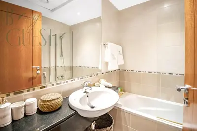 a bathroom with a sink and a bath tub at Stunning 2BR Holiday Home JBR Views Dubai Marina in Dubai