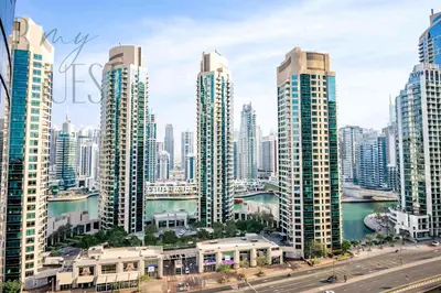 a city skyline with tall skyscrapers and a freeway at Stunning 2BR Holiday Home JBR Views Dubai Marina in Dubai