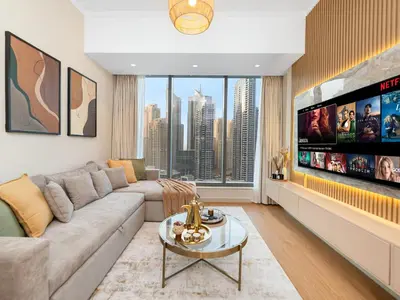 a living room with a couch and a tv at Livora Stays - Marina Promenade , Walk to JBR in Dubai