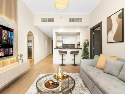 a living room with a couch and a table at Livora Stays - Marina Promenade , Walk to JBR in Dubai