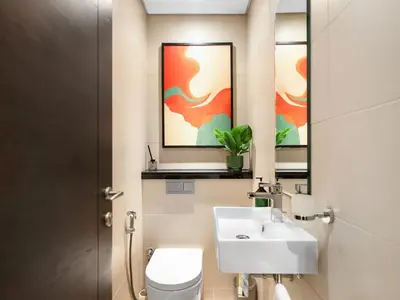 a bathroom with a sink and a toilet and a mirror at Livora Stays - Marina Promenade , Walk to JBR in Dubai