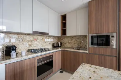 a kitchen with white cabinets and a sink at GuestReady - 2BR City View | Canal | High Floor in Dubai