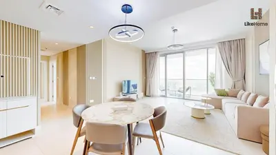 a living room with a table and a couch at Grand Apartment -3 Bedrooms in Dubai