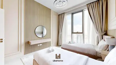 a hotel room with two beds and a mirror at Grand Apartment -3 Bedrooms in Dubai