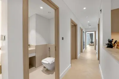 a bathroom with a toilet in the middle of a hallway at Direct Burj & Fountain Views - Designer 4BR Haven! in Dubai