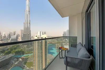 an apartment balcony with a view of the city at Direct Burj & Fountain Views - Designer 4BR Haven! in Dubai