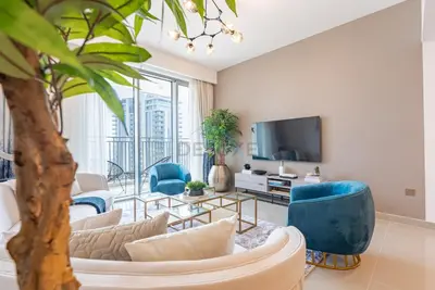 a living room with a couch and chairs and a tv at Apartment with Stunning Canal Views, Just Minutes from Dubai Mall and Burj Khalifa - 17 Icon Bay, Dubai Creek Harbour by Deluxe Holiday Homes in Dubai