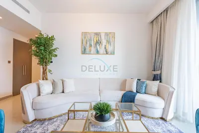 a living room with a white couch and a table at Apartment with Stunning Canal Views, Just Minutes from Dubai Mall and Burj Khalifa - 17 Icon Bay, Dubai Creek Harbour by Deluxe Holiday Homes in Dubai