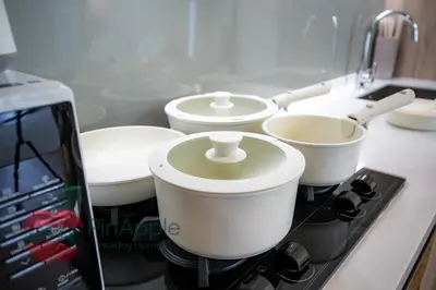 a counter with four pots on a stove in a kitchen at Brand New with Burj Khalifa View in Dubai
