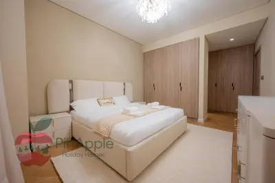 a bedroom with a large white bed in a room at Brand New with Burj Khalifa View in Dubai