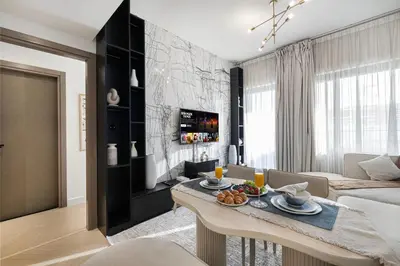 a living room with a table and a couch at Deluxe Binghatti Suites by Hostiva - Burj View in Dubai