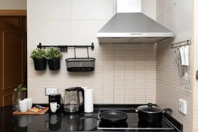 a kitchen with a stove with pots and pans on the wall at Entire Apartment in Dubai Marina in Dubai