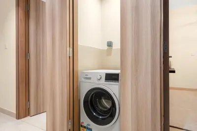 a washer and dryer in a small room at Cozy 2BR with Canal View & Partial Burj View in Dubai
