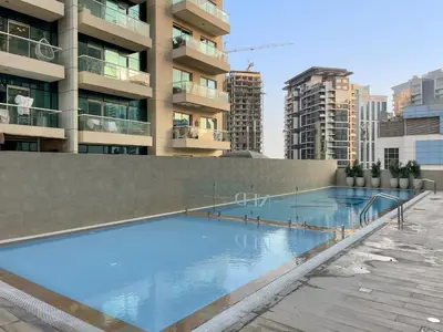 a large swimming pool on top of a building at Cozy 2BR with Canal View & Partial Burj View in Dubai