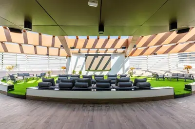 a large room with chairs and tables and grass at Limited Time l Private Pool I Elegance l Prime Location in Dubai
