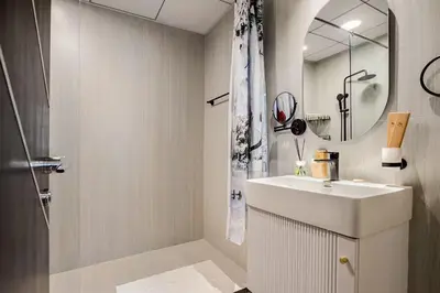 a white bathroom with a sink and a mirror at Limited Time l Private Pool I Elegance l Prime Location in Dubai