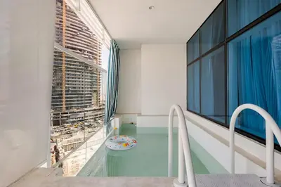 a swimming pool in a building with a window at Limited Time l Private Pool I Elegance l Prime Location in Dubai
