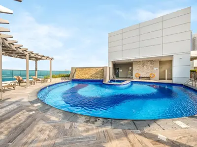 a swimming pool on the roof of a building at Stylish 1BR Near Burj Khalifa with Rooftop Pool, City Views, Free Parking in Dubai