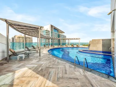 a swimming pool on the roof of a building at Stylish 1BR Near Burj Khalifa with Rooftop Pool, City Views, Free Parking in Dubai