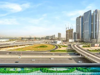 a highway in a city with tall buildings at Stylish 1BR Near Burj Khalifa with Rooftop Pool, City Views, Free Parking in Dubai