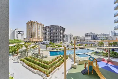 a view of a pool and a playground at Bright Studio Retreat in Floarea Residence Arjan in Dubai