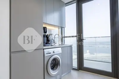a kitchen with a washing machine in front of a window at Bloomfieilds Spacious 1br Azizi Fawad in Dubai