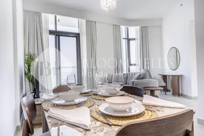 a dining room with a table and chairs at Bloomfieilds Spacious 1br Azizi Fawad in Dubai