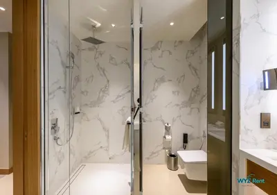 a bathroom with a shower and a toilet at FULL Burj Khalifa View Luxe 3BR in Address Opera in Dubai
