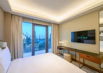 a hotel room with a bed and a flat screen tv at FULL Burj Khalifa View Luxe 3BR in Address Opera in Dubai