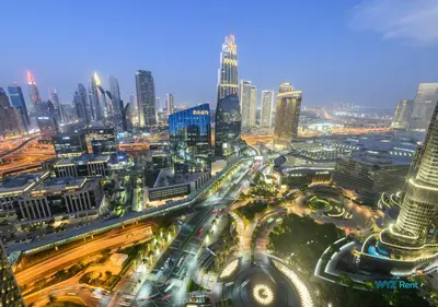 an aerial view of a city at night with traffic at FULL Burj Khalifa View Luxe 3BR in Address Opera in Dubai