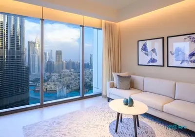 a living room with a white couch and a large window at FULL Burj Khalifa View Luxe 3BR in Address Opera in Dubai