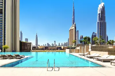 a swimming pool with a view of the city at Modern 1BR Near Dubai Mall in Downtown Views II in Dubai