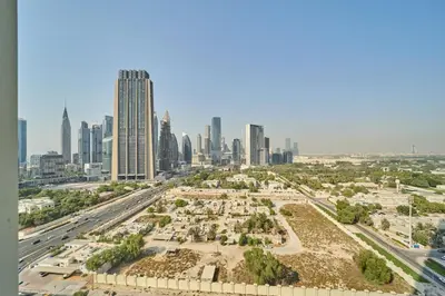 an aerial view of a park in front of a city at Modern 1BR Near Dubai Mall in Downtown Views II in Dubai