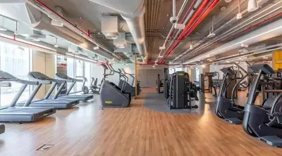 a gym with treadmills and elliptical machines at Modern 1BR Near Dubai Mall in Downtown Views II in Dubai