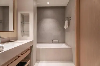 a bathroom with a tub and a sink at GuestReady - 1BR Near Dubai Mall | Downtown Stay in Dubai