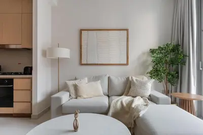a living room with a couch and a table at GuestReady - 1BR Near Dubai Mall | Downtown Stay in Dubai