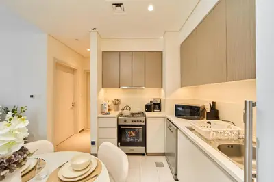 a kitchen with a sink and a stove at Your Dubai Hills Retreat 1BR in Park Heights 2 in Dubai