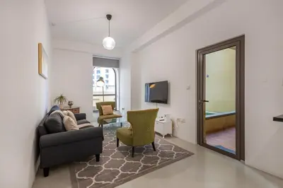 a living room with a couch and a mirror at Bahar 1, JBR - 2 Bedroom Apartment - Allsopp & Allsopp in Dubai