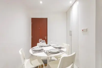 a white dining room with a white table and white chairs at Bahar 1, JBR - 2 Bedroom Apartment - Allsopp & Allsopp in Dubai