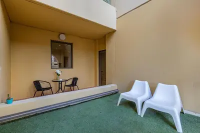 two white chairs and a table in a room at Bahar 1, JBR - 2 Bedroom Apartment - Allsopp & Allsopp in Dubai