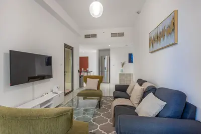 a living room with a couch and chairs and a tv at Bahar 1, JBR - 2 Bedroom Apartment - Allsopp & Allsopp in Dubai